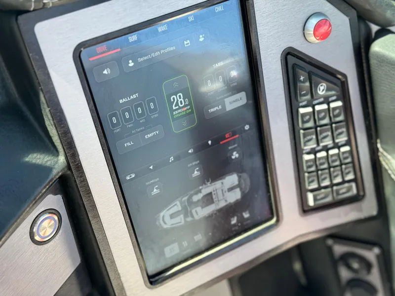Slide: The Image of 2022 MasterCraft XStar S dashboard with touchscreen controls and digital display. - 44