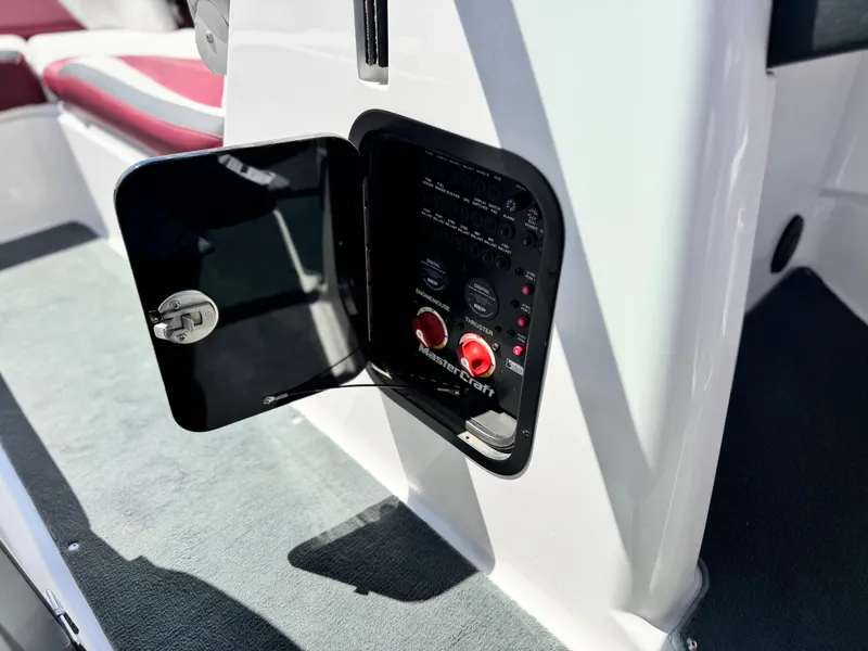 Slide: The Image of 2022 MasterCraft XStar S boat control panel with open access door. - 45