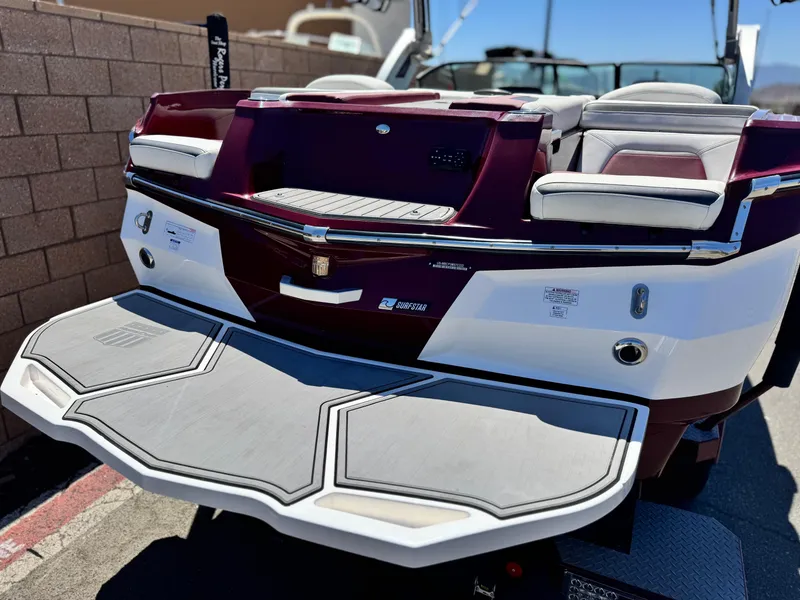 Slide: The Image of 2022 MasterCraft XStar S boat rear view with swim platform and seating. - 6