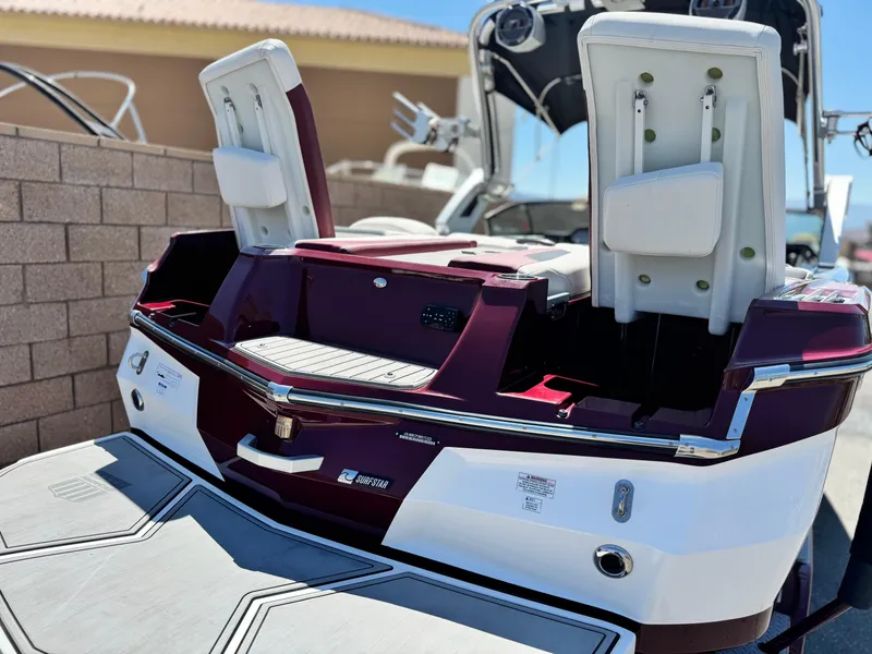 Slide: The Image of 2022 MasterCraft XStar S boat with open rear seating and sleek design. - 7