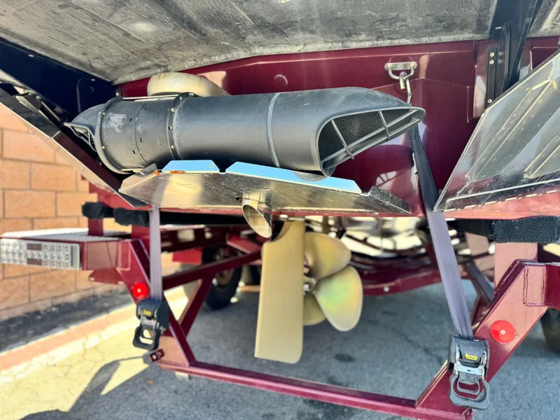 Slide: The Image of Rear view of a 2022 MasterCraft XStar S boat, showcasing propeller and exhaust system. - 9