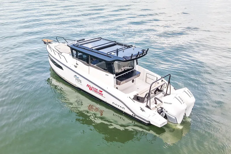 Slide: The Image of 2025 Navan C30 boat on water, featuring sleek design and powerful Mercury engines. - 1