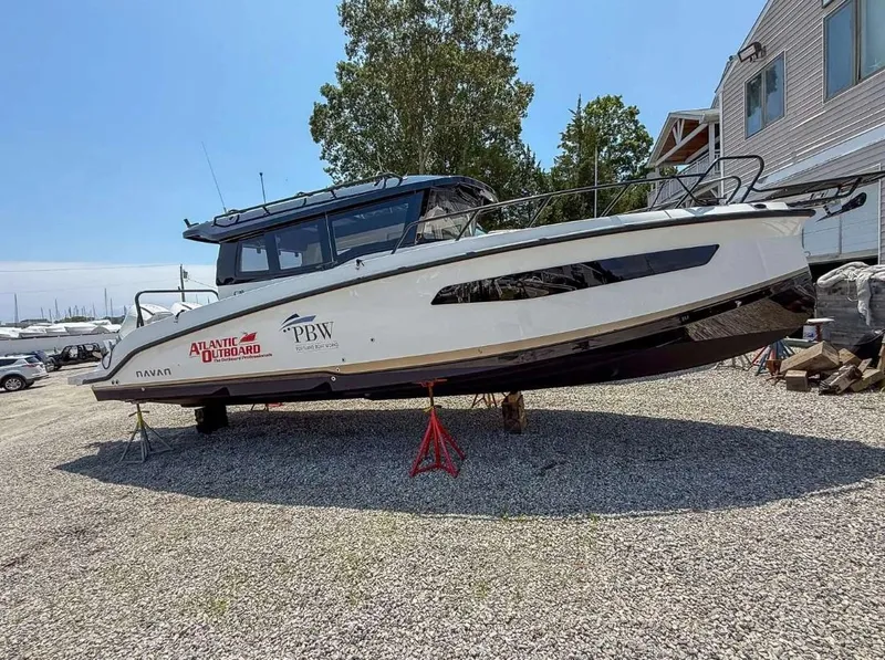 Slide: The Image of 2025 Navan C30 boat on stands, displayed outdoors near a building. - 11