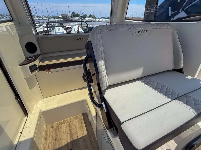 Slide: The Image of Interior of 2025 Navan C30 boat with cushioned seating and wood flooring. - 14