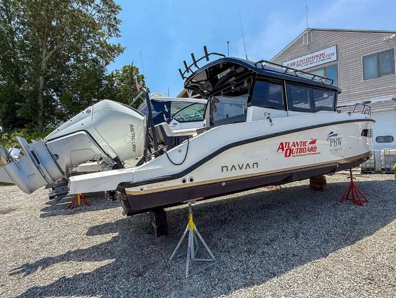 Slide: The Image of 2025 Navan C30 boat with Mercury outboard engines on display at a marine center. - 17