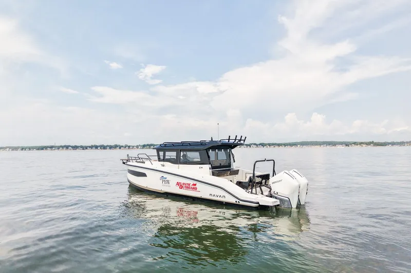 Slide: The Image of 2025 Navan C30 boat on calm water under a clear sky. - 2