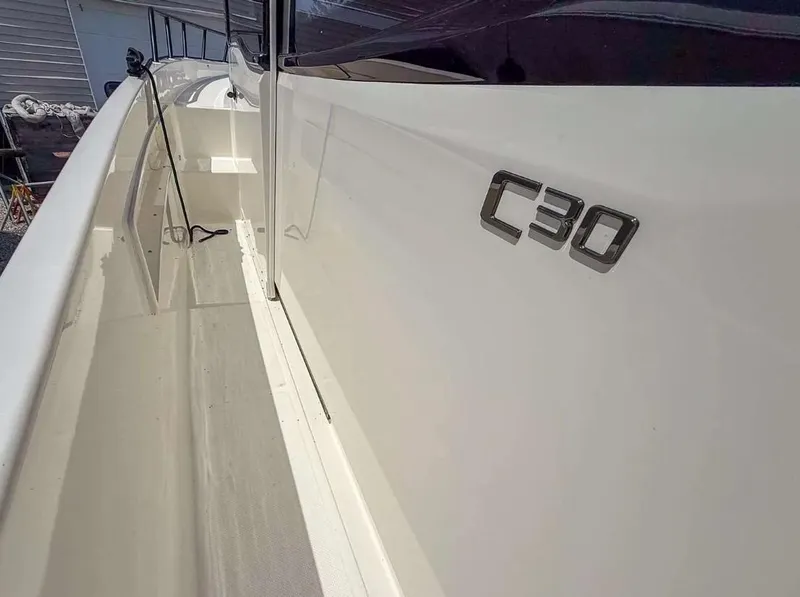 Slide: The Image of Navan C30 2025 boat side view with sleek white design and logo. - 23