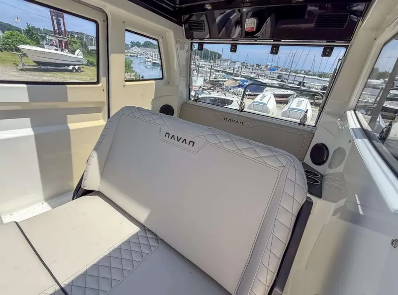 Slide: The Image of Interior of 2025 Navan C30 boat with luxurious seating and marina view. - 26