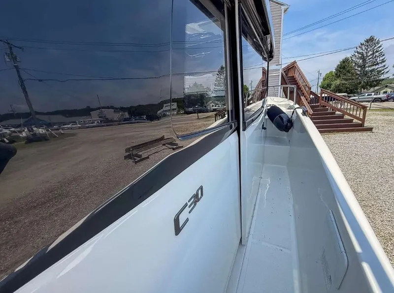 Slide: The Image of 2025 Navan C30 boat exterior with sleek design and reflective windows. - 30