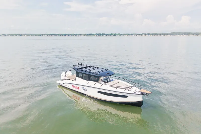 Slide: The Image of Navan C30 2025 boat cruising on calm waters under a clear sky. - 7