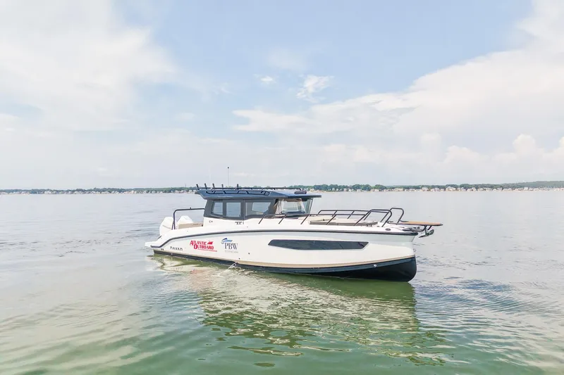 Slide: The Image of Navan C30 2025 boat cruising on a calm lake under a clear sky. - 8