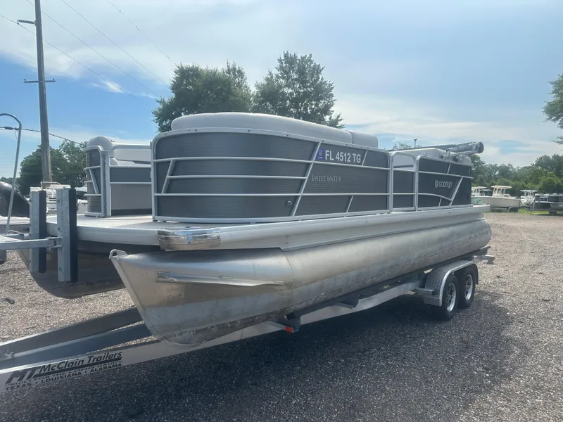 Slide: The Image of 2022 Godfrey SWEETWATER 2286 SB pontoon boat on trailer, parked outdoors. - 1