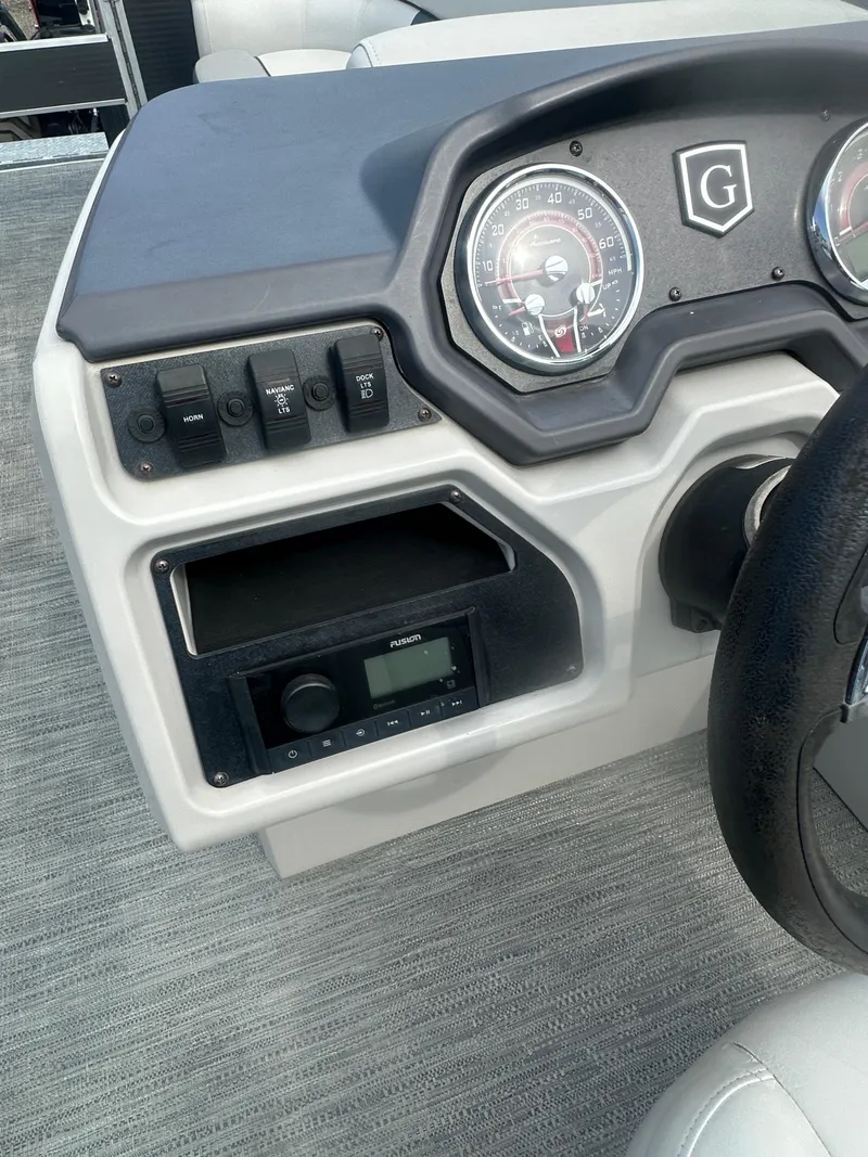 Slide: The Image of Dashboard of 2022 Godfrey SWEETWATER 2286 SB boat with controls and gauges. - 16