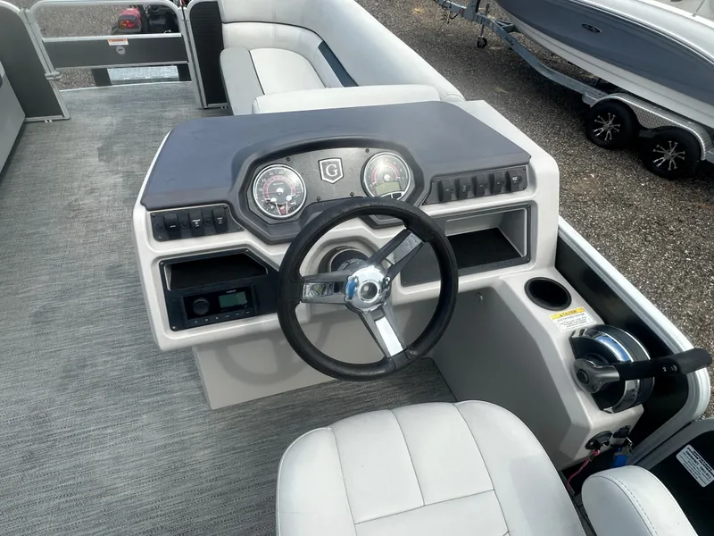 Slide: The Image of 2022 Godfrey SWEETWATER 2286 SB boat dashboard with steering wheel and controls. - 17