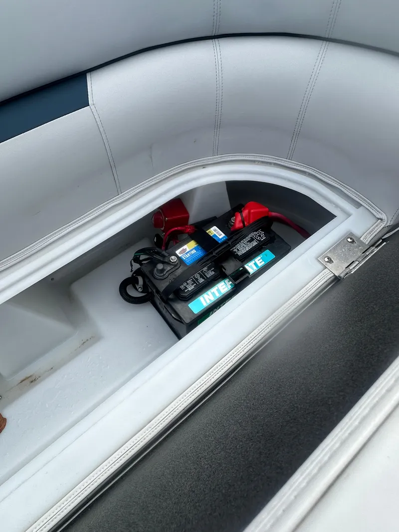 Slide: The Image of Battery compartment of 2022 Godfrey SWEETWATER 2286 SB boat, featuring an Interstate battery. - 18