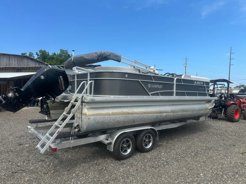 Slide: The Image of 2022 Godfrey SWEETWATER 2286 SB pontoon boat on trailer, parked outdoors. - 5