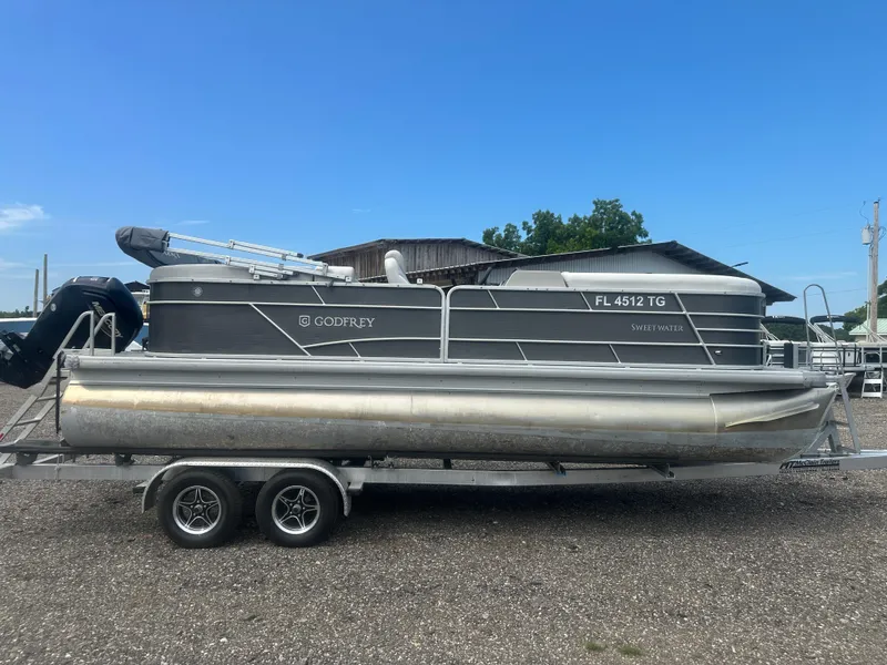 Slide: The Image of 2022 Godfrey SWEETWATER 2286 SB pontoon boat on trailer, parked outdoors. - 6