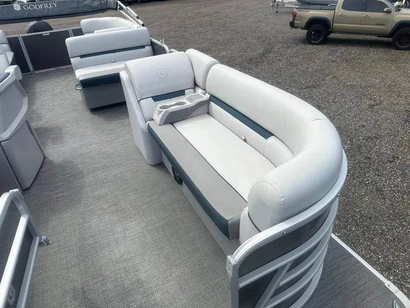 Slide: The Image of 2022 Godfrey SWEETWATER 2286 SB pontoon boat interior with plush seating and cup holders. - 9