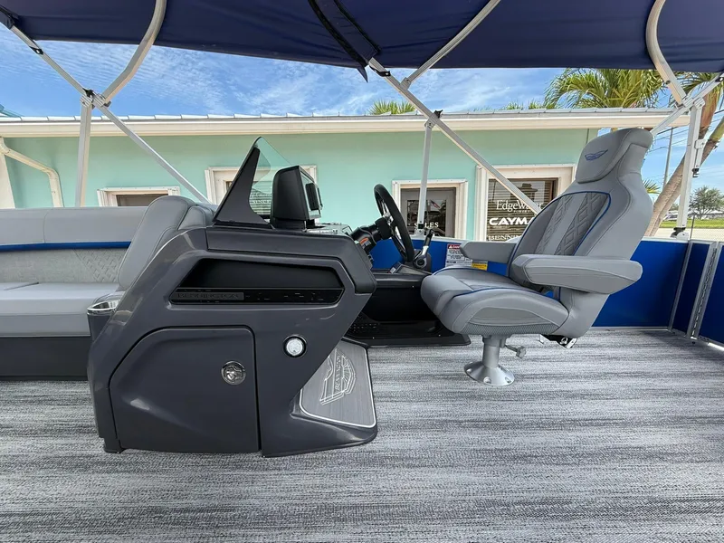 Slide: The Image of 2026 Bennington 22 MSB boat interior with modern helm and seating under canopy. - 13