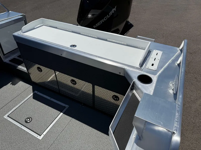 Slide: The Image of 2025 Thunder Jet 210 Luxor boat deck with storage compartments and Mercury engine. - 11