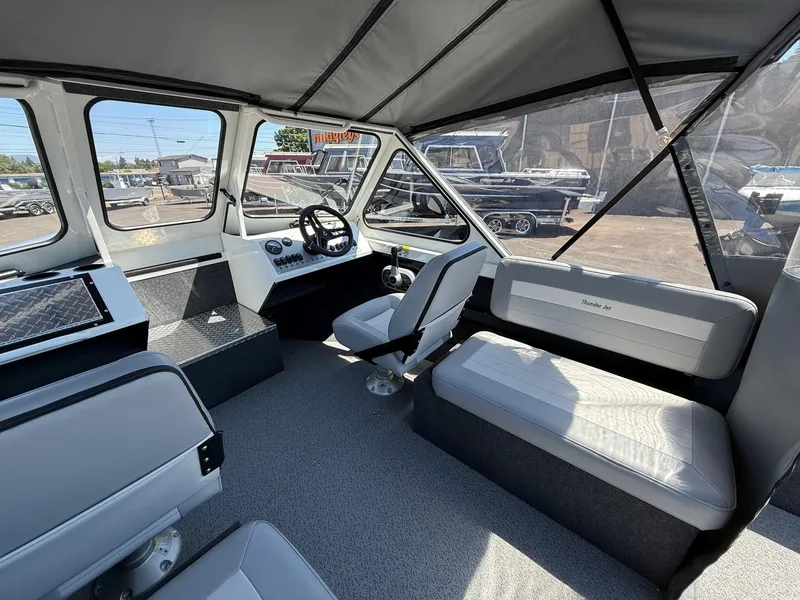 Slide: The Image of Interior of 2025 Thunder Jet 210 Luxor boat, featuring modern seating and steering console. - 18