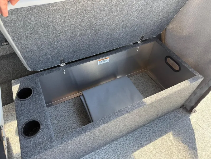 Slide: The Image of Open storage compartment in 2025 Thunder Jet 210 Luxor boat with cup holders. - 19
