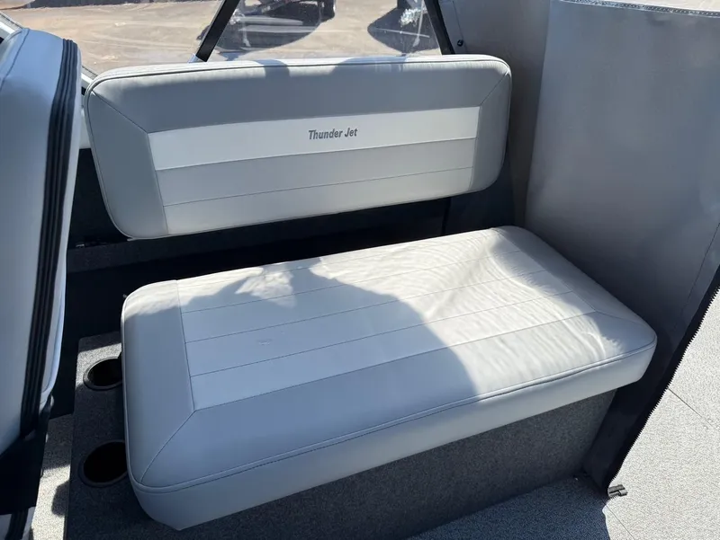 Slide: The Image of 2025 Thunder Jet 210 Luxor boat interior with cushioned seating and cup holders. - 20