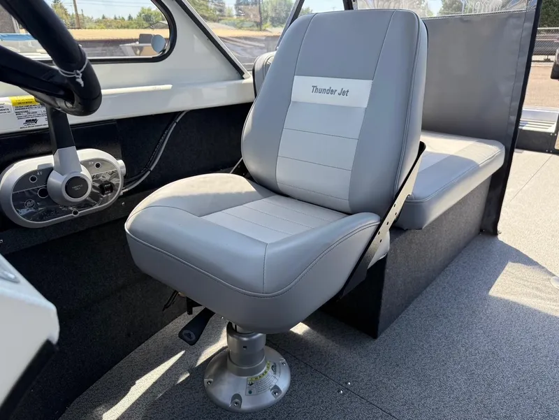 Slide: The Image of 2025 Thunder Jet 210 Luxor interior with gray seating and steering console. - 21