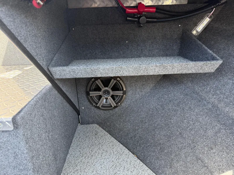 Slide: The Image of Interior of 2025 Thunder Jet 210 Luxor boat with speaker and carpeted storage area. - 28