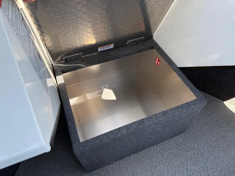 Slide: The Image of Storage compartment in 2025 Thunder Jet 210 Luxor boat, featuring durable metal and carpeted interior. - 29