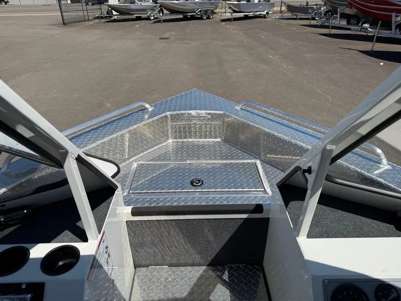 Slide: The Image of 2025 Thunder Jet 210 Luxor boat interior with diamond plate flooring and open bow area. - 30
