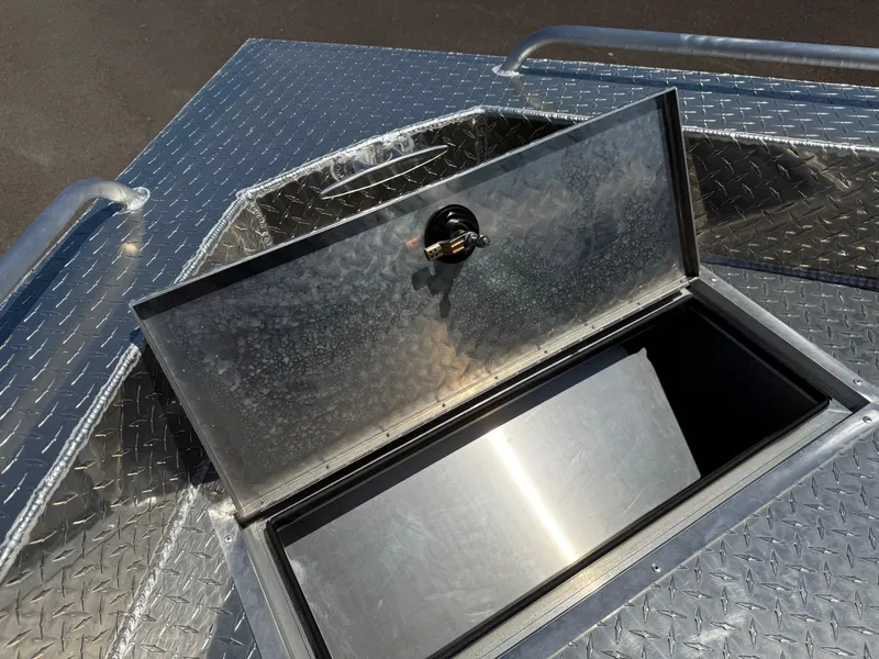 Slide: The Image of Open storage compartment on 2025 Thunder Jet 210 Luxor boat with diamond plate finish. - 31