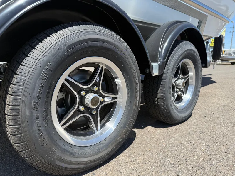 Slide: The Image of Trailer wheels of a 2025 Thunder Jet 210 Luxor boat on asphalt. - 34