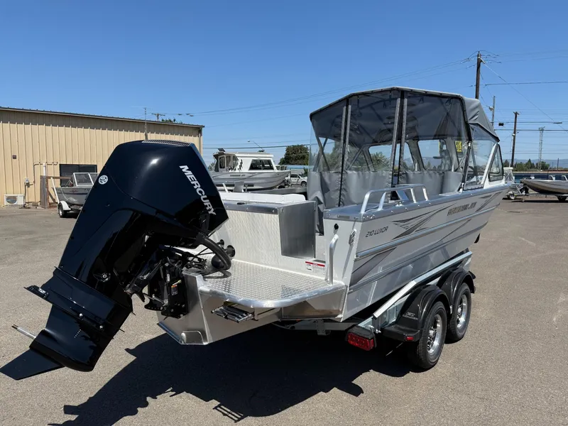 Slide: The Image of 2025 Thunder Jet 210 Luxor boat with Mercury outboard motor, parked on a trailer. - 5