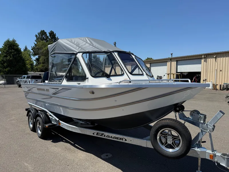 Slide: The Image of 2025 Thunder Jet 210 Luxor boat on trailer, parked outdoors under clear sky. - 7