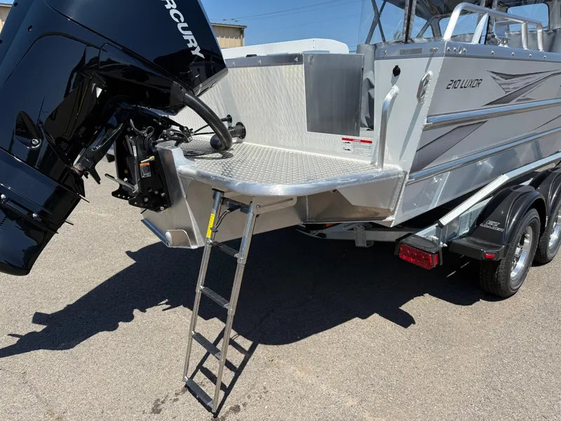 Slide: The Image of 2025 Thunder Jet 210 Luxor boat with Mercury engine and rear ladder on trailer. - 8