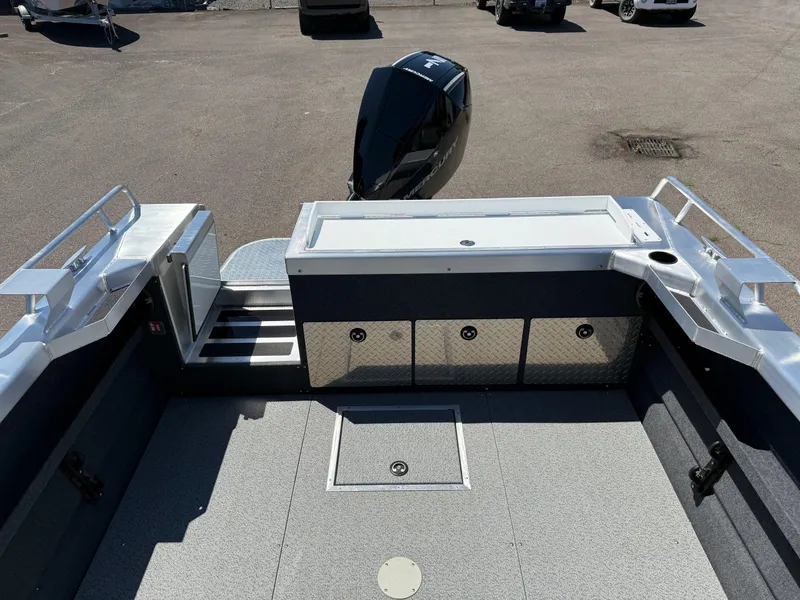 Slide: The Image of 2025 Thunder Jet 210 Luxor boat interior with storage compartments and outboard motor. - 9