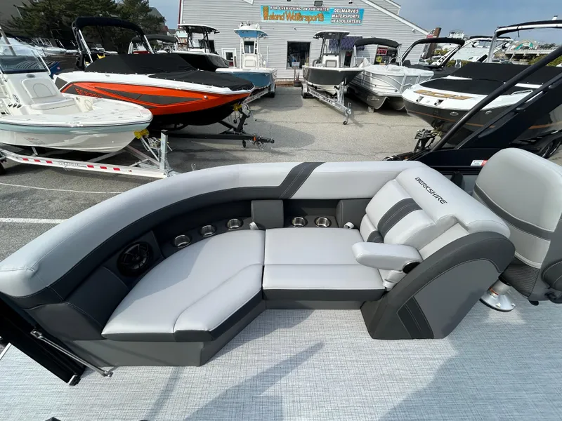 Slide: The Image of 2025 Berkshire 22RFX ARCH CTS 2.75 pontoon boat interior with luxurious seating at a dealership. - 13