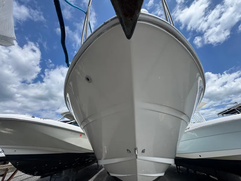 Slide: The Image of 2003 Sea Ray 280 Sundancer boat under a cloudy blue sky. - 1
