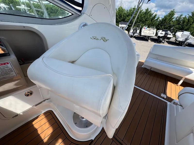 Slide: The Image of White captain's chair on 2003 Sea Ray 280 Sundancer boat, with teak flooring. - 10