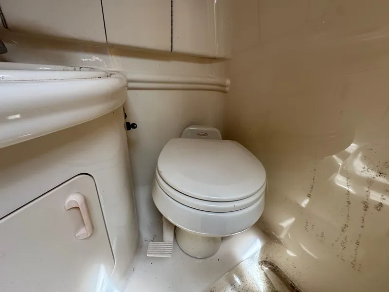 Slide: The Image of 2003 Sea Ray 280 Sundancer boat bathroom with toilet and sink. - 18