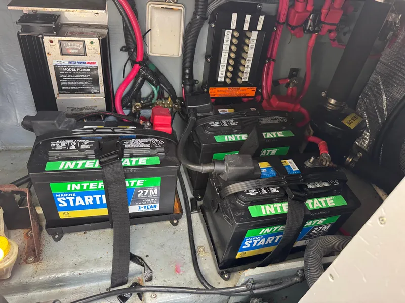 Slide: The Image of Marine batteries and wiring inside a 2003 Sea Ray 280 Sundancer boat. - 21