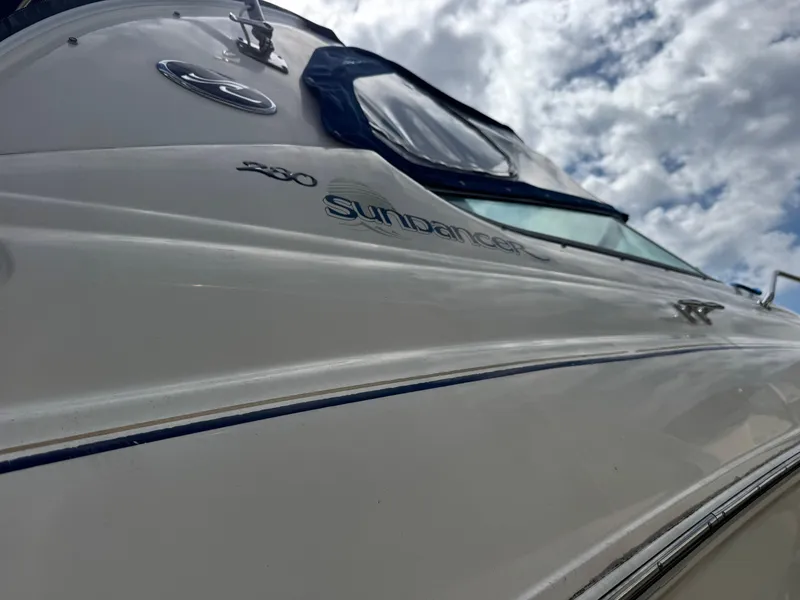 Slide: The Image of 2003 Sea Ray 280 Sundancer boat under cloudy sky, side view. - 3