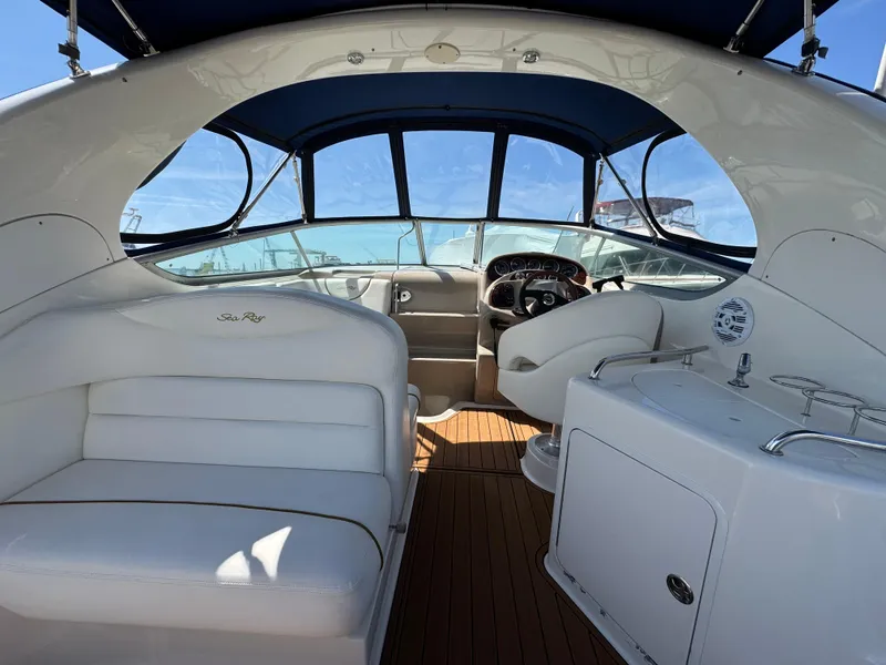 Slide: The Image of 2003 Sea Ray 280 Sundancer interior with white seating and wooden flooring. - 7