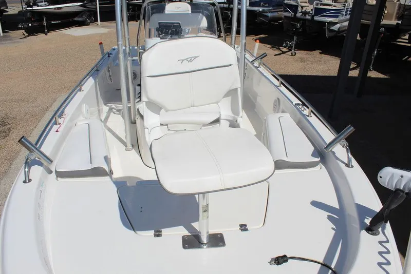 Slide: The Image of 2015 Tidewater Bay Max 2100 boat interior with white seating and fishing rod holders. - 12