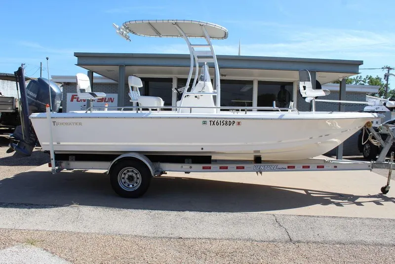 Slide: The Image of 2015 Tidewater Bay Max 2100 boat on trailer, parked outside a building. - 3