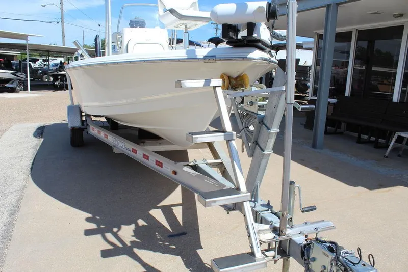 Slide: The Image of 2015 Tidewater Bay Max 2100 boat on trailer, parked outside a building. - 6