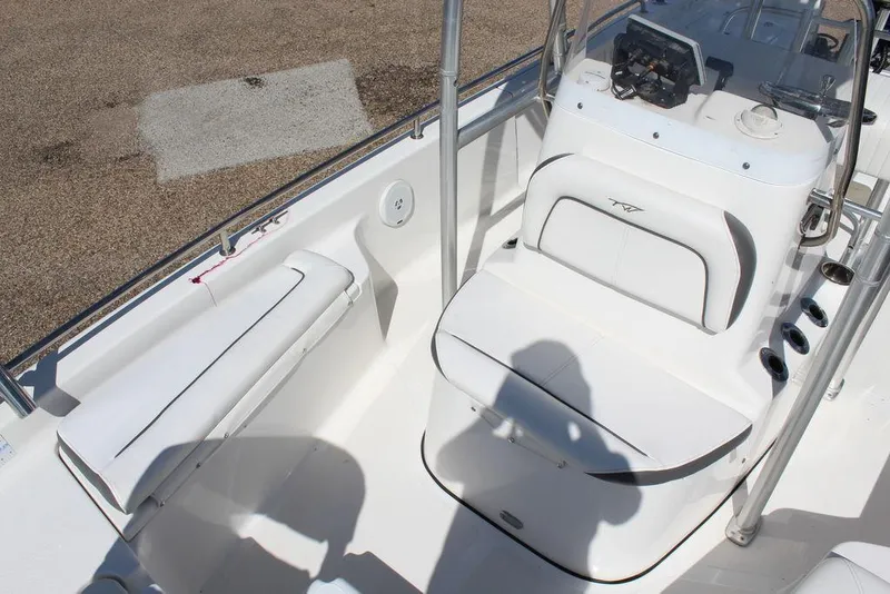 Slide: The Image of 2015 Tidewater Bay Max 2100 boat interior with white seating and console. - 7