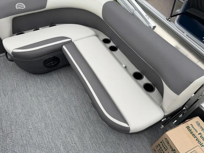 Slide: The Image of 2026 Sun Tracker Bass Buggy 16 XL boat interior with gray seating and cup holders. - 11