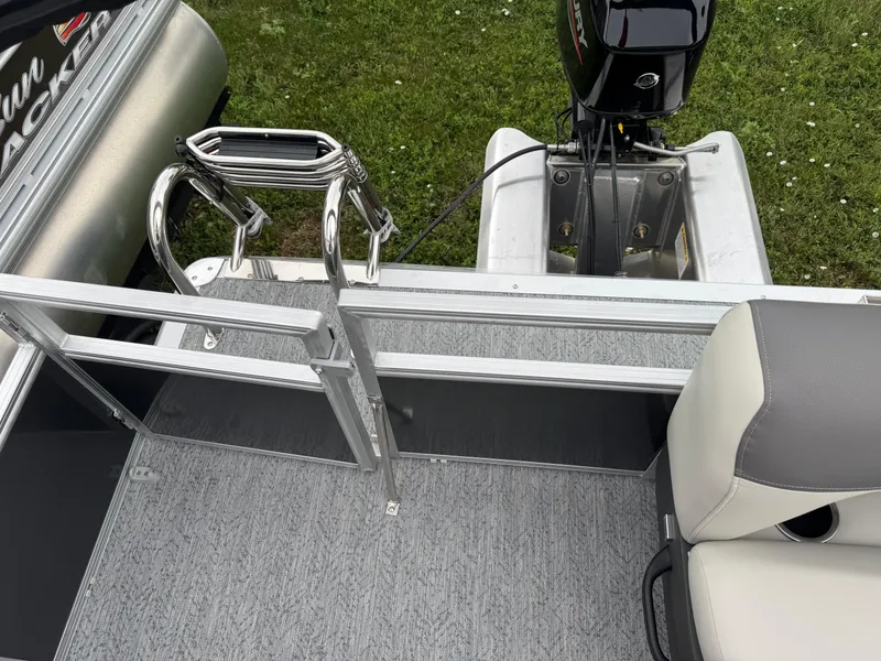 Slide: The Image of 2026 Sun Tracker Bass Buggy 16 XL pontoon boat with motor and seating area. - 16